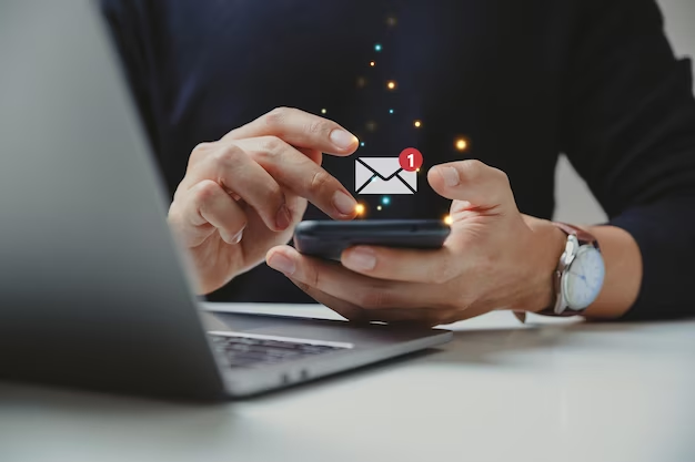 Man using a smartphone with an email icon